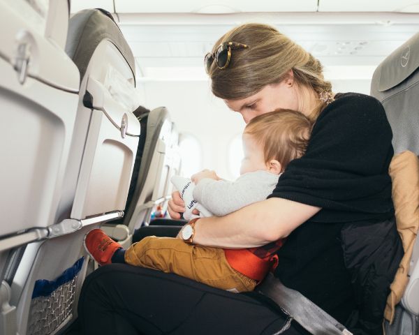 mom on airplane learning how to travel with breast milk